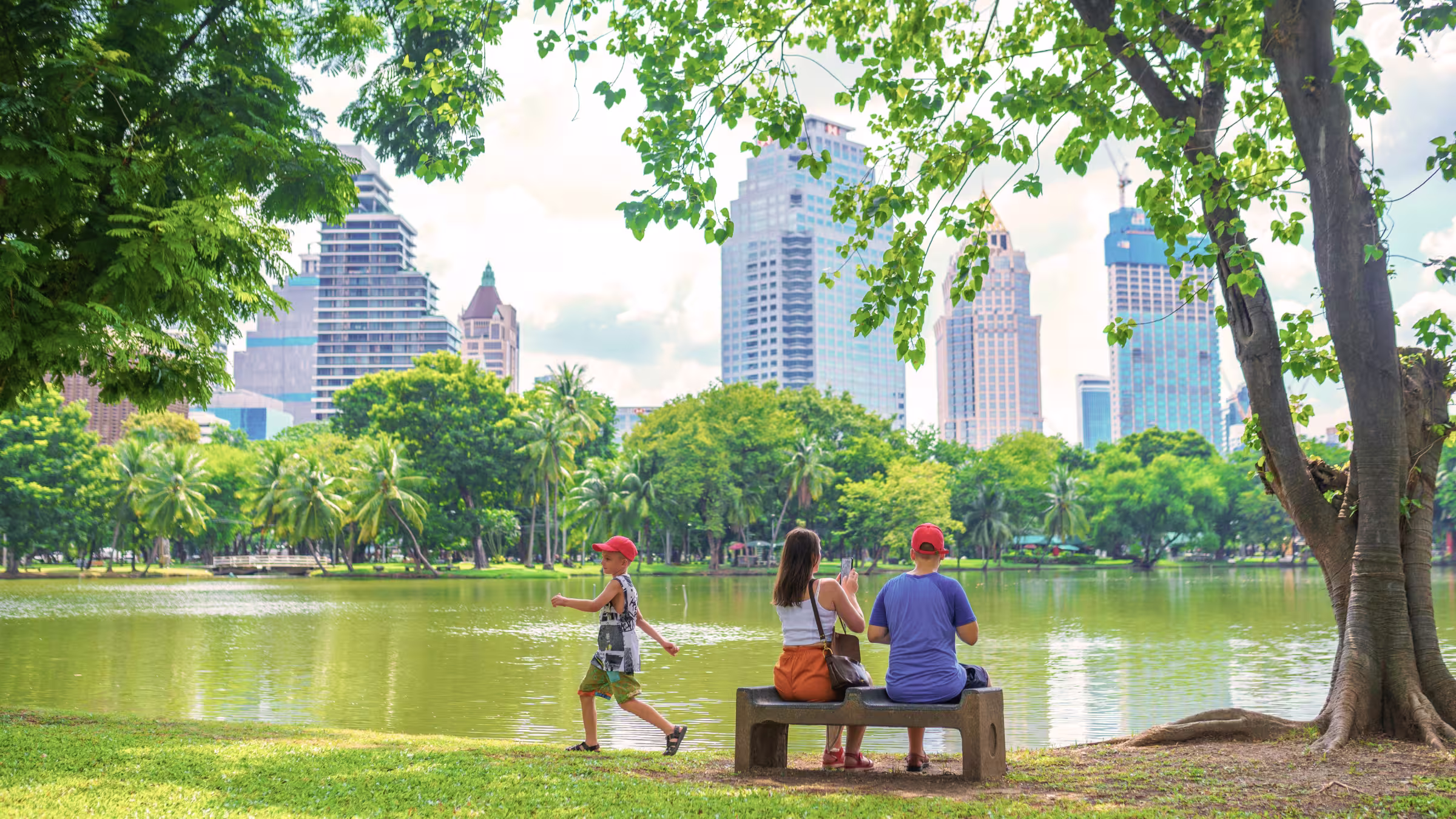 Family enjoying time by Lumpini park in Bangkok city